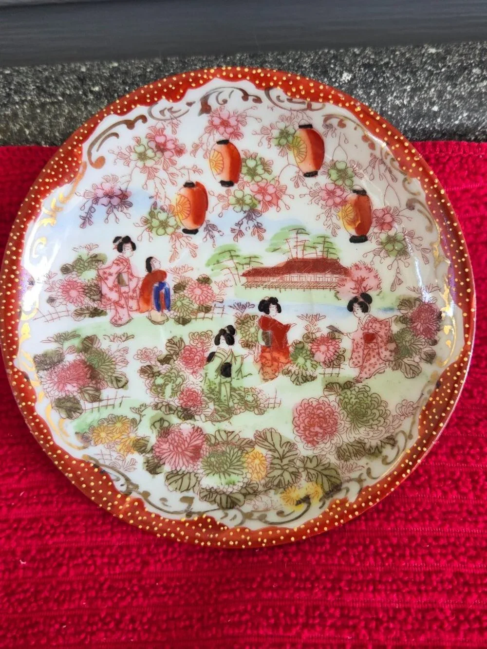 Japanese hand painted porcelain demitasse cup and saucer Geisha garden gilt trim